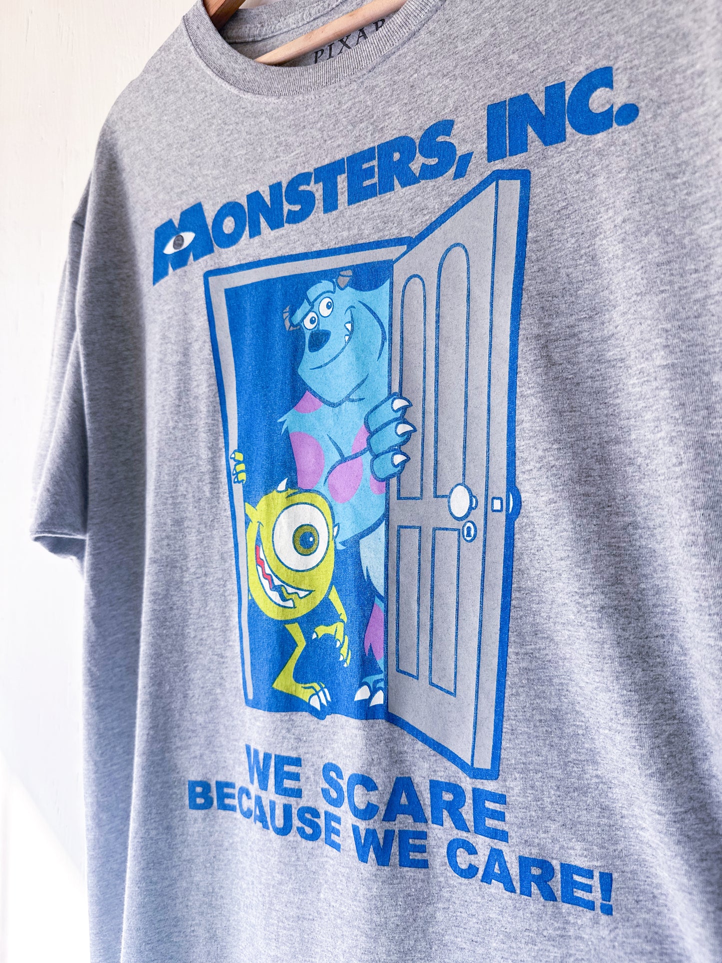 Monster’s Inc ‘Scare BC We Care’ Tee - L